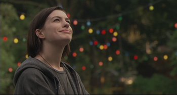 Movie still from “Rachel Getting Married” (2008), directed by Jonathan Demme – A woman is looking up at the lights; Close Up shot, Over the shoulder angle