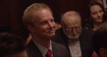 Movie still from “Rachel Getting Married” (2008), directed by Jonathan Demme – A man in a suit and tie next to another man in a suit; Close Up shot, Over the shoulder angle