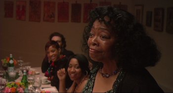 Movie still from “Rachel Getting Married” (2008), directed by Jonathan Demme – A group of people sitting around a table; Close Up shot, Over the shoulder angle