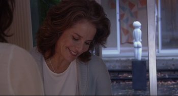 Movie still from “Rachel Getting Married” (2008), directed by Jonathan Demme – A person sitting on a chair; Close Up shot, Over the shoulder angle