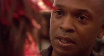 Movie still from “Rachel Getting Married” (2008), directed by Jonathan Demme – A man's face in front of red leaves; Close Up shot, Over the shoulder angle