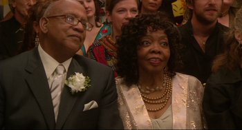 Movie still from “Rachel Getting Married” (2008), directed by Jonathan Demme – A man and a woman are standing in front of a crowd; Close Up shot, High angle
