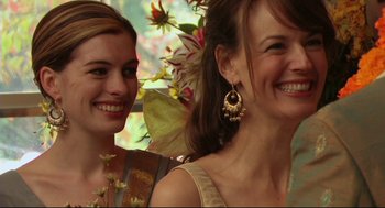 Movie still from “Rachel Getting Married” (2008), directed by Jonathan Demme – Two beautiful women standing next to each other in front of flowers; Close Up shot, Over the shoulder angle