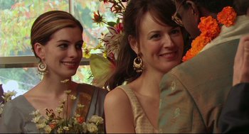 Movie still from “Rachel Getting Married” (2008), directed by Jonathan Demme – Two women and a man smile for the camera; Close Up shot, Over the shoulder angle