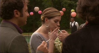 Movie still from “Rachel Getting Married” (2008), directed by Jonathan Demme – A man and a woman standing next to each other; Medium shot, Over the shoulder angle