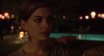 Movie still from “Rachel Getting Married” (2008), directed by Jonathan Demme – A beautiful woman with long brown hair wearing gold earrings; Close Up shot, Over the shoulder angle