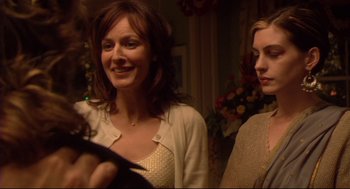 Movie still from “Rachel Getting Married” (2008), directed by Jonathan Demme – Two women standing next to each other in front of a flower arrangement; Close Up shot, Over the shoulder angle