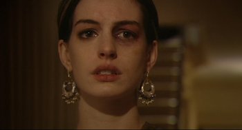 Movie still from “Rachel Getting Married” (2008), directed by Jonathan Demme – A person wearing earrings and looking at the camera; Close Up shot, Low angle
