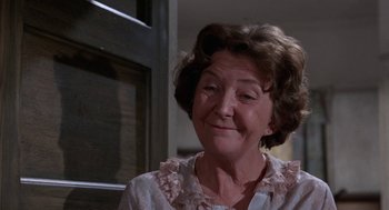 Movie still from “Rachel, Rachel” (1968), directed by Paul Newman – An older woman is smiling for the camera; Close Up shot, Over the shoulder angle