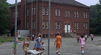 Movie still from “Rachel, Rachel” (1968), directed by Paul Newman – A group of children playing in a playground; Extreme Wide shot, High angle