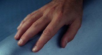 Movie still from “Rachel, Rachel” (1968), directed by Paul Newman – View of a person's hand on a blue surface; Extreme Close Up shot, Overhead angle