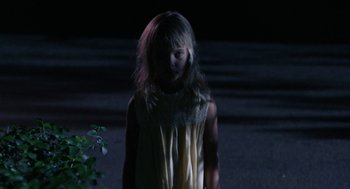Movie still from “Rachel, Rachel” (1968), directed by Paul Newman – A little girl standing in the dark with her hair blowing in the wind; Medium shot, High angle