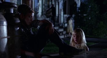 Movie still from “Rachel, Rachel” (1968), directed by Paul Newman – A boy and a little girl sitting on the ground in front of a house; Medium shot, Low angle