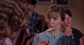 Movie still from “Rachel, Rachel” (1968), directed by Paul Newman – A woman holding a white flower in her hand; Close Up shot, Over the shoulder angle