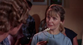 Movie still from “Rachel, Rachel” (1968), directed by Paul Newman – A woman is holding a flower in her hand; Close Up shot, Over the shoulder angle