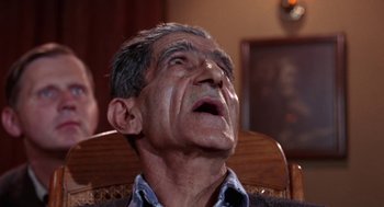 Movie still from “Rachel, Rachel” (1968), directed by Paul Newman – An older man is sitting in a wooden chair; Close Up shot, Low angle