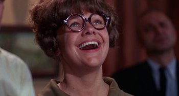 Movie still from “Rachel, Rachel” (1968), directed by Paul Newman – A person wearing glasses and smiling; Close Up shot, Low angle