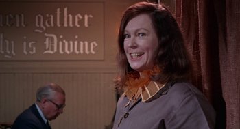 Movie still from “Rachel, Rachel” (1968), directed by Paul Newman – A woman in a gray jacket and a yellow ribbon around her neck; Close Up shot, Low angle