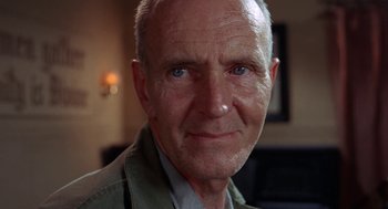 Movie still from “Rachel, Rachel” (1968), directed by Paul Newman – An older man with a goatee is smiling for the camera; Close Up shot, Low angle