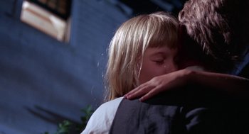 Movie still from “Rachel, Rachel” (1968), directed by Paul Newman – A little girl is hugging a man in a dark room; Close Up shot, Over the shoulder angle