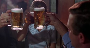 Movie still from “Rachel, Rachel” (1968), directed by Paul Newman – A group of people drinking beer at a bar; Close Up shot, Over the shoulder angle