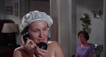 Movie still from “Rachel, Rachel” (1968), directed by Paul Newman – A woman in a shower cap talking on a phone; Close Up shot, High angle
