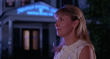 Movie still from “Rachel, Rachel” (1968), directed by Paul Newman – A woman is standing in front of a building at night; Close Up shot, Low angle