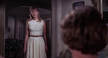 Movie still from “Rachel, Rachel” (1968), directed by Paul Newman – A woman standing in front of a mirror in a room; Medium shot, Over the shoulder angle