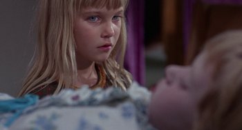 Movie still from “Rachel, Rachel” (1968), directed by Paul Newman – A young girl looking at the camera with a doll in front of her; Close Up shot, Over the shoulder angle