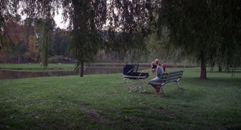 Movie still from “Rachel, Rachel” (1968), directed by Paul Newman – Two people sitting on a bench near a body of water; Extreme Wide shot, High angle