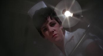 Movie still from “Rachel, Rachel” (1968), directed by Paul Newman – A woman with short black hair is looking at the camera; Close Up shot, Low angle