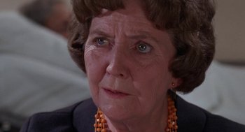 Movie still from “Rachel, Rachel” (1968), directed by Paul Newman – An older woman wearing orange beads looking at the camera; Close Up shot, Over the shoulder angle