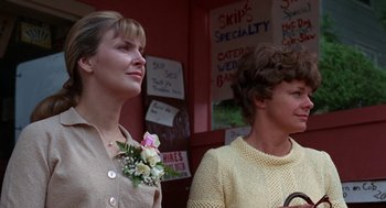 Movie still from “Rachel, Rachel” (1968), directed by Paul Newman – Two women standing next to each other in front of signs; Close Up shot, Low angle