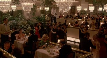 Movie still from “Radio Days” (1987), directed by Woody Allen – A group of people sitting at a table in a restaurant; Extreme Wide shot, High angle