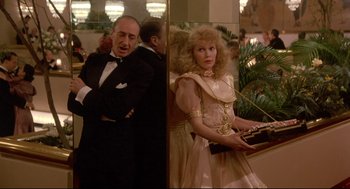 Movie still from “Radio Days” (1987), directed by Woody Allen – A man and a woman standing next to each other in a room; Medium shot, Low angle