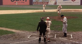 Movie still from “Radio Days” (1987), directed by Woody Allen – A group of baseball players standing on top of a baseball field; Wide shot, High angle