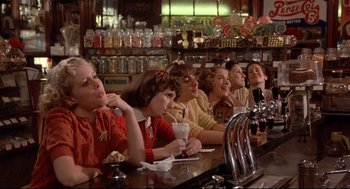 Movie still from “Radio Days” (1987), directed by Woody Allen – A group of people sitting at a bar drinking; Medium shot, Low angle