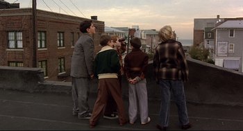 Movie still from “Radio Days” (1987), directed by Woody Allen – A group of people standing next to each other on a street; Wide shot, High angle