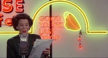 Movie still from “Radio Days” (1987), directed by Woody Allen – A woman standing in front of a neon sign reading " good to the last drop "; Close Up shot, Low angle