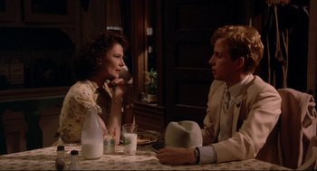 Movie still from “Radio Days” (1987), directed by Woody Allen – A man and a woman sitting at a dinner table; Medium shot, Over the shoulder angle