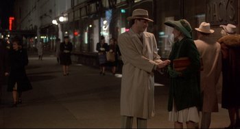 Movie still from “Radio Days” (1987), directed by Woody Allen – A man and a woman are standing on the sidewalk; Wide shot, Over the shoulder angle