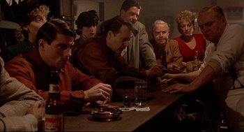 Movie still from “Radio Days” (1987), directed by Woody Allen – A group of people sitting around a table; Medium shot, High angle