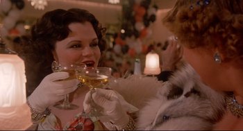 Movie still from “Radio Days” (1987), directed by Woody Allen – A woman holding a glass of wine in her hand; Close Up shot, Over the shoulder angle