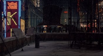Movie still from “Radio Days” (1987), directed by Woody Allen – A stage in the middle of a street at night; Extreme Wide shot, Low angle