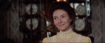 Movie still from “Ragtime” (1981), directed by Milos Forman – A person wearing a dress; Close Up shot, Over the shoulder angle