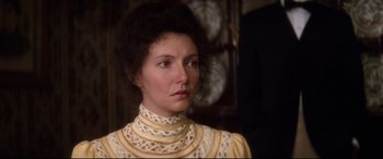 Movie still from “Ragtime” (1981), directed by Milos Forman – A person wearing a dress; Close Up shot, Over the shoulder angle