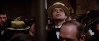 Movie still from “Ragtime” (1981), directed by Milos Forman – A man wearing a straw hat and a bow tie; Close Up shot, Low angle