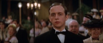 Movie still from “Ragtime” (1981), directed by Milos Forman – A man in a suit and bow tie; Close Up shot, Low angle