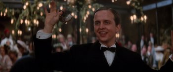 Movie still from “Ragtime” (1981), directed by Milos Forman – A man in a suit and bow tie holding a camera; Close Up shot, Low angle