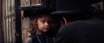 Movie still from “Ragtime” (1981), directed by Milos Forman – A young girl looking at a man in a top hat; Close Up shot, Over the shoulder angle